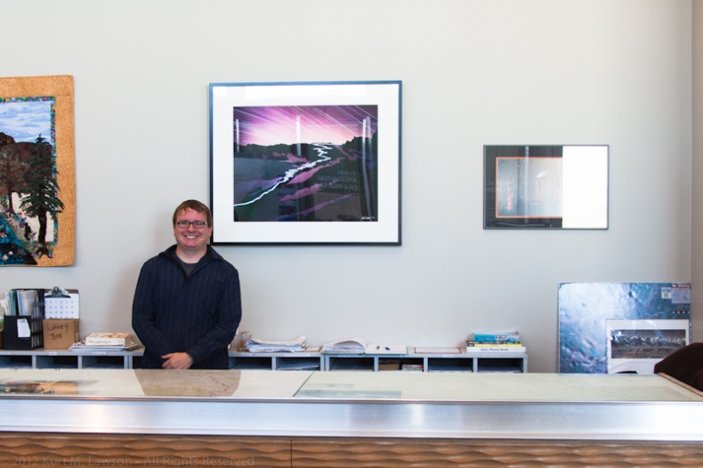 Kurt stands next to his photo
