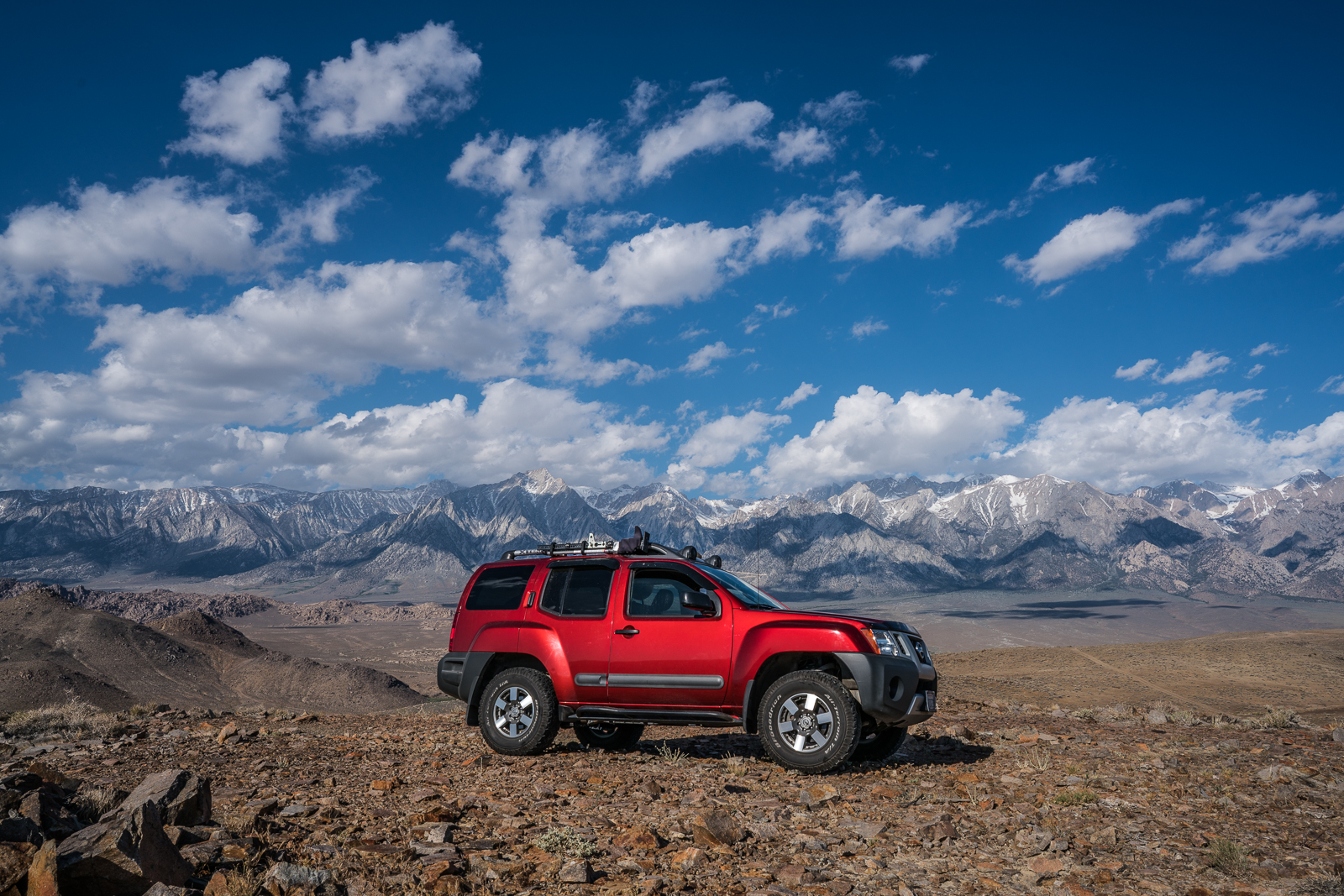 xterra on top of the alabama hills in california wit the sierra nevada mountains behind